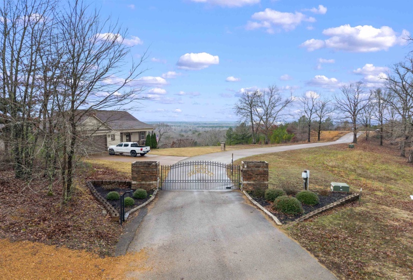 View of asphalt road featuring a gate