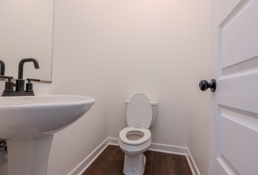 Bathroom featuring hardwood / wood-style flooring, sink, and toilet