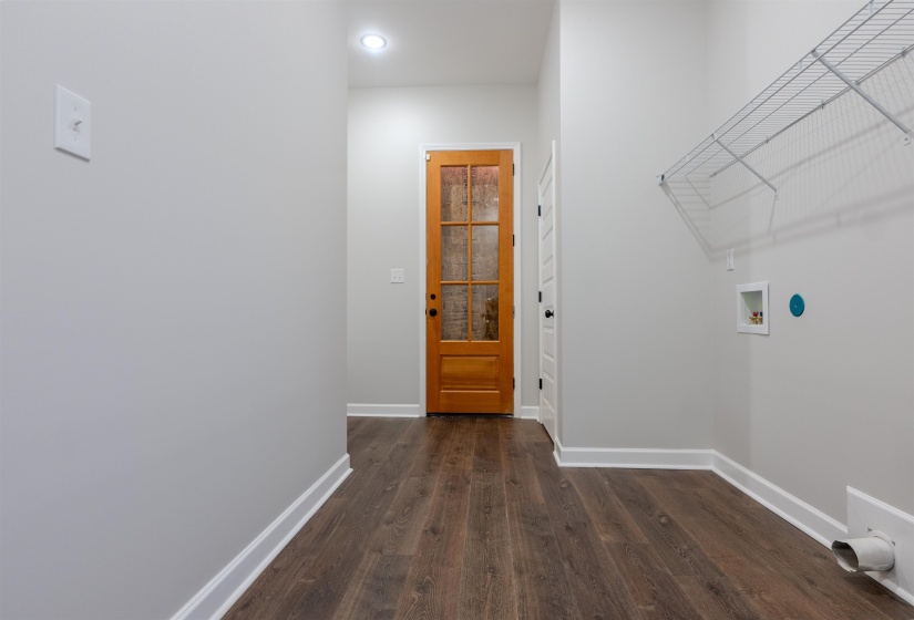 Laundry room featuring washer hookup and dark hardwood / wood-style flooring