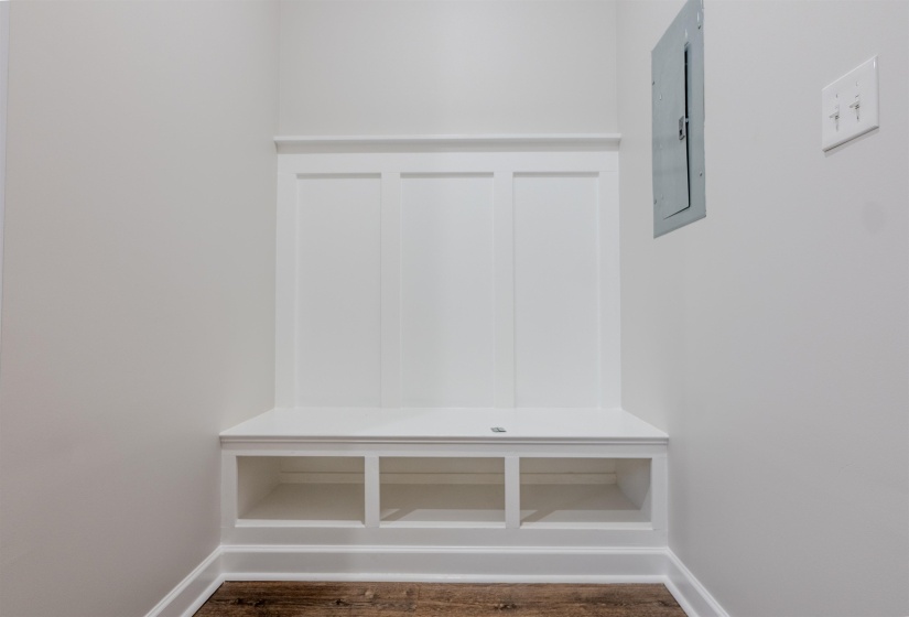 Mudroom with electric panel and dark wood-type flooring