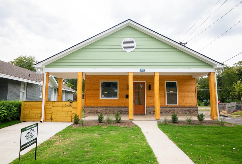 Bungalow featuring covered porch and a front yard
