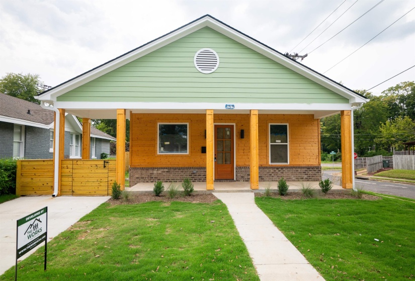 Bungalow with a porch and a front lawn