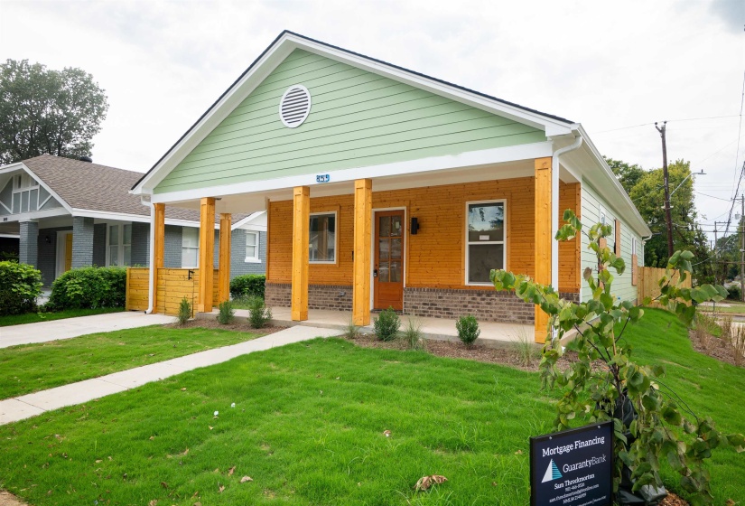 View of front facade featuring covered porch and a front yard