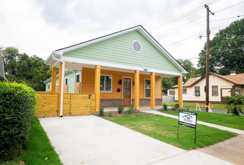 Bungalow-style home featuring a front yard and covered porch