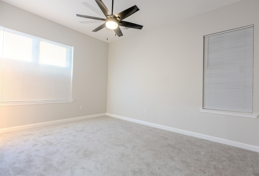 Empty room with ceiling fan and carpet