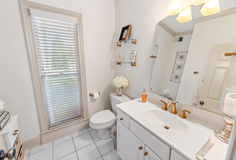 Bathroom with tile patterned floors, vanity, ornamental molding, toilet, and an enclosed shower