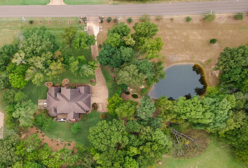 Birds eye view of property with a water view
