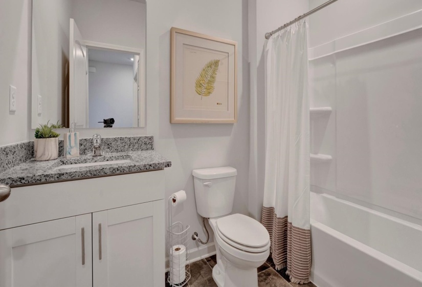 Full bathroom featuring shower / tub combo, vanity, and toilet
