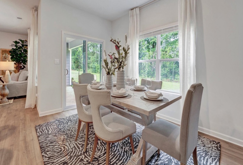 Dining area with light hardwood / wood-style flooring