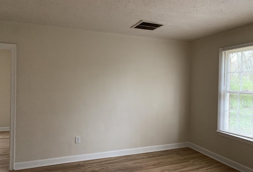 Unfurnished room featuring plenty of natural light, hardwood / wood-style floors, and a textured ceiling
