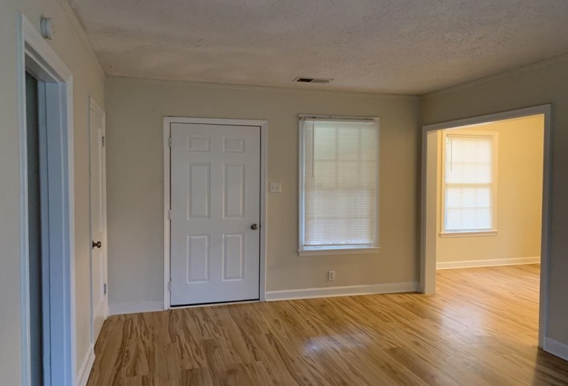 Spare room featuring light hardwood / wood-style floors and a textured ceiling