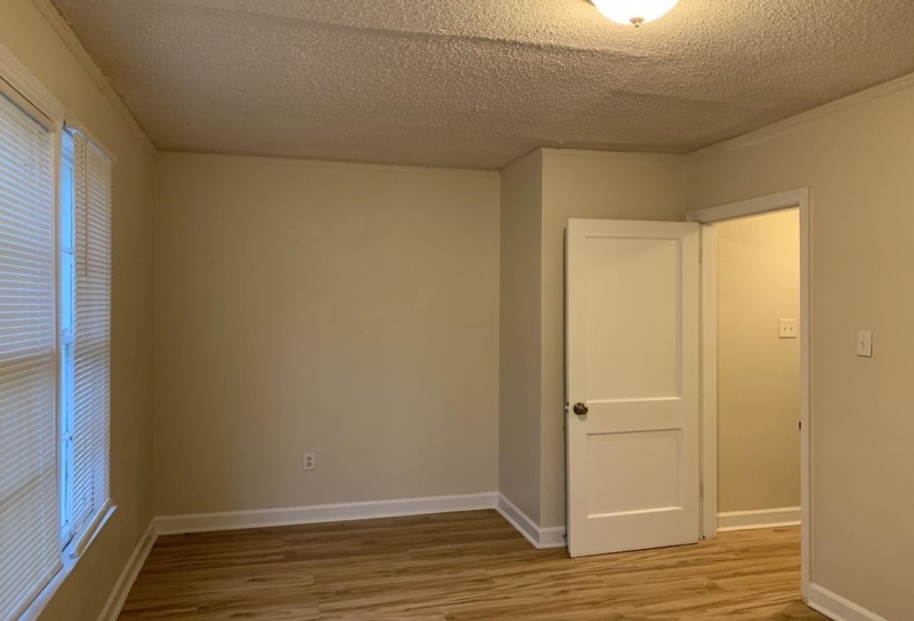 Unfurnished room featuring hardwood / wood-style floors and a textured ceiling
