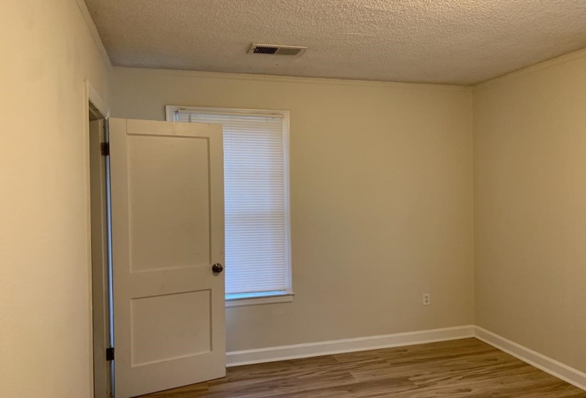 Empty room featuring hardwood / wood-style floors and a textured ceiling