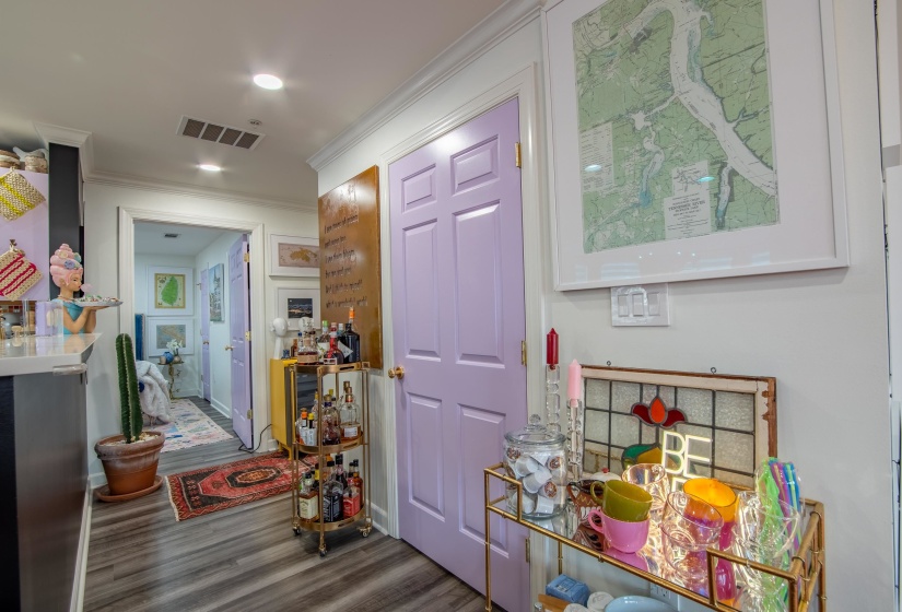 Corridor with dark wood-type flooring and ornamental molding