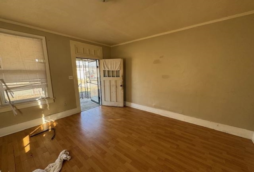 Empty room with crown molding and dark hardwood / wood-style floors