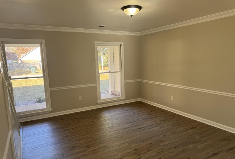 Unfurnished room featuring dark wood-type flooring and ornamental molding