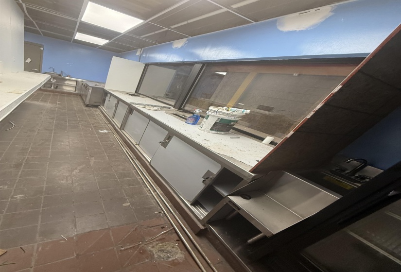 Kitchen with a drop ceiling and white cabinets
