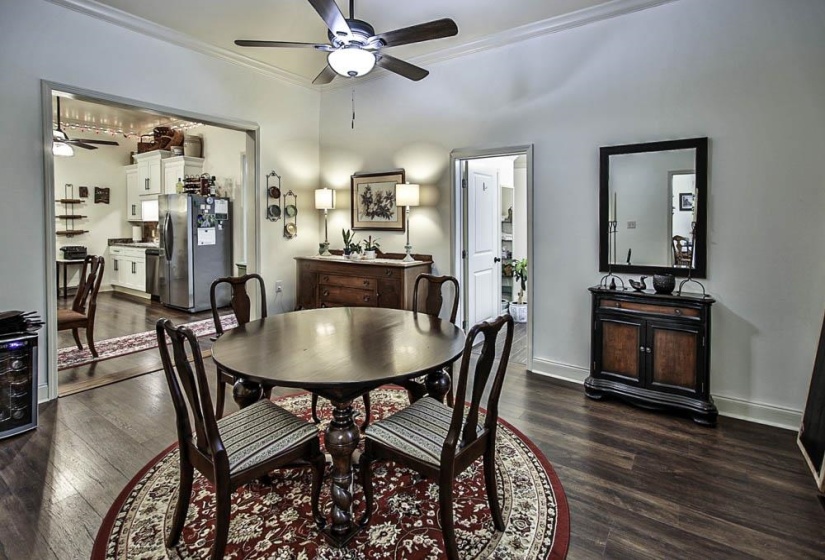 Dining space featuring crown molding, dark hardwood / wood-style floors, and ceiling fan