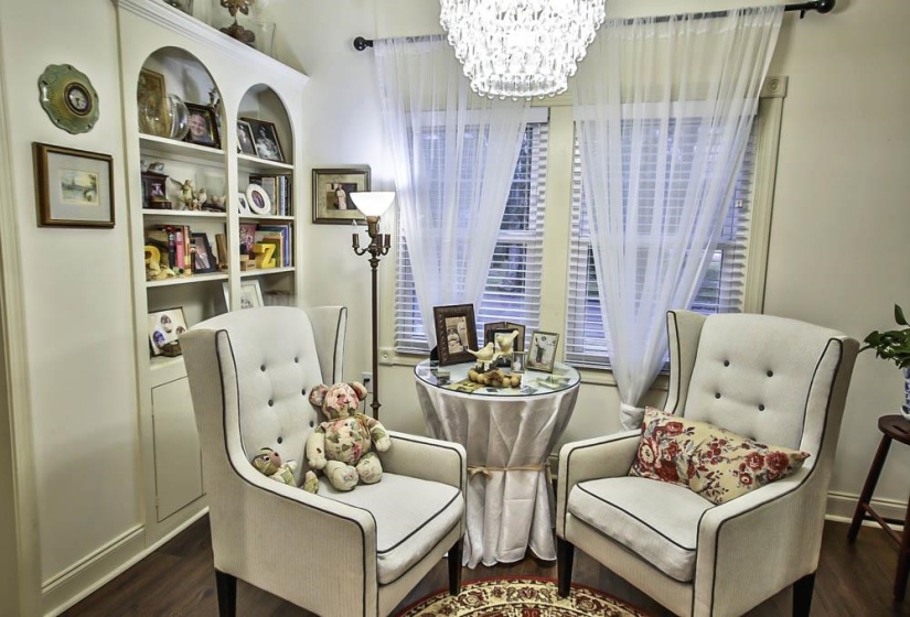 Sitting room with dark wood-type flooring and a notable chandelier