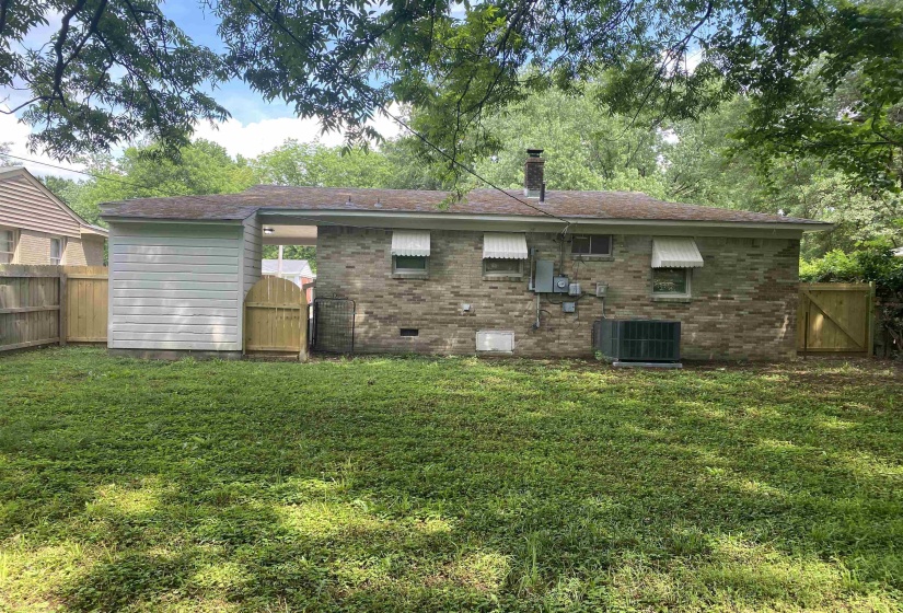 Back of house with a lawn and central air condition unit