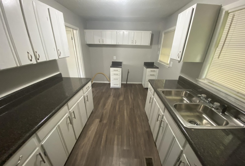 Kitchen with sink, white cabinets, and dark hardwood / wood-style flooring