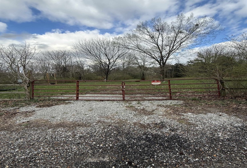 View of yard featuring a rural view and a gate
