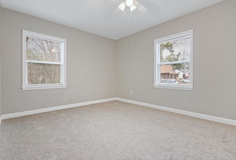 Empty room with ceiling fan and carpet