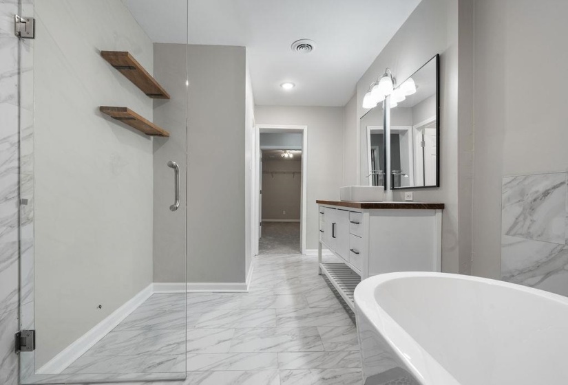 Bathroom featuring plus walk in shower and vanity