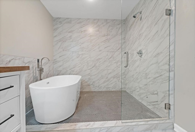 Bathroom with separate shower and tub and tile walls