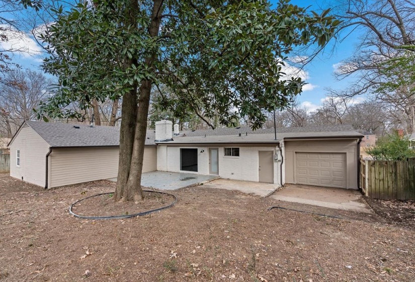 Exterior space with a garage and a patio area, slab for storage building