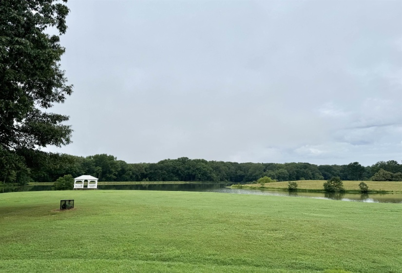 View of property's community with a yard and a water view