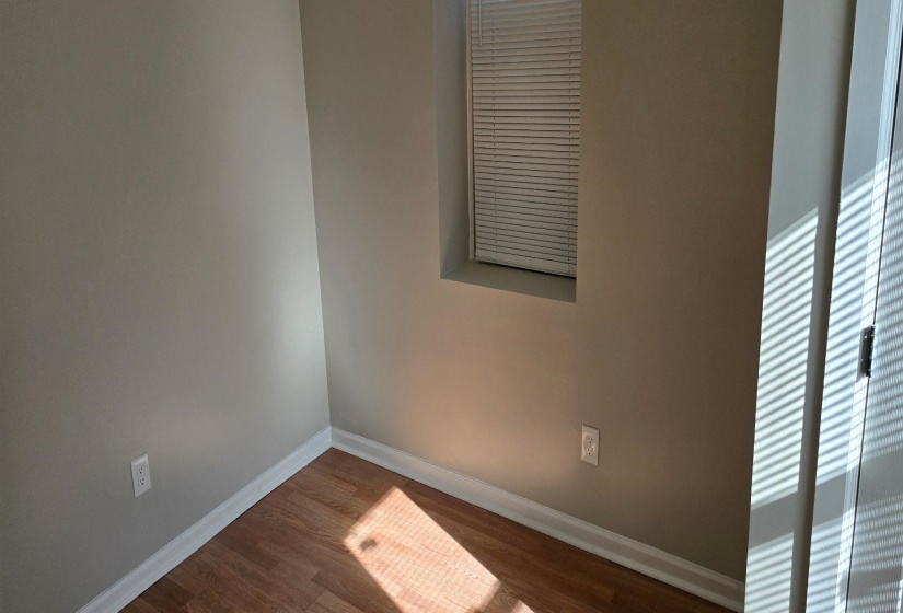 Unfurnished room with dark wood-type flooring