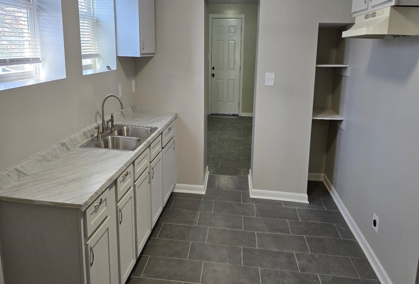 Kitchen with sink and dark tile patterned flooring