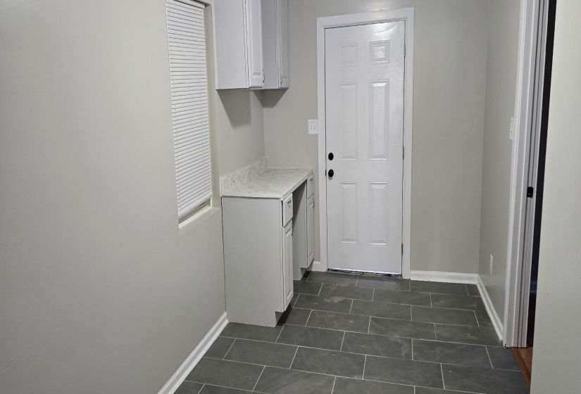 Washroom featuring dark tile patterned floors