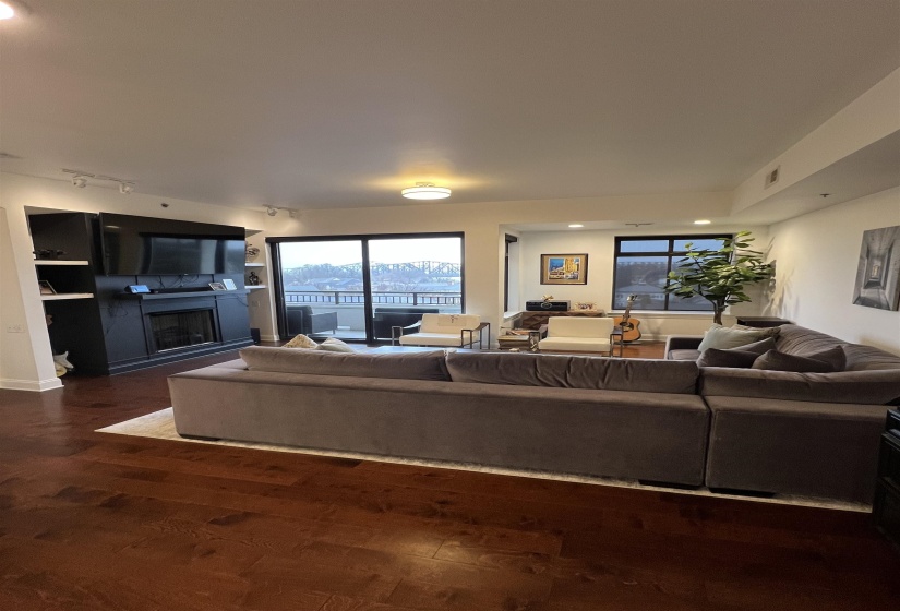 Living room featuring rail lighting and dark hardwood / wood-style floors