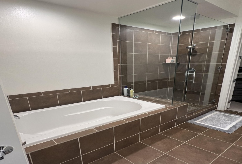Bathroom with plus walk in shower and tile patterned floors