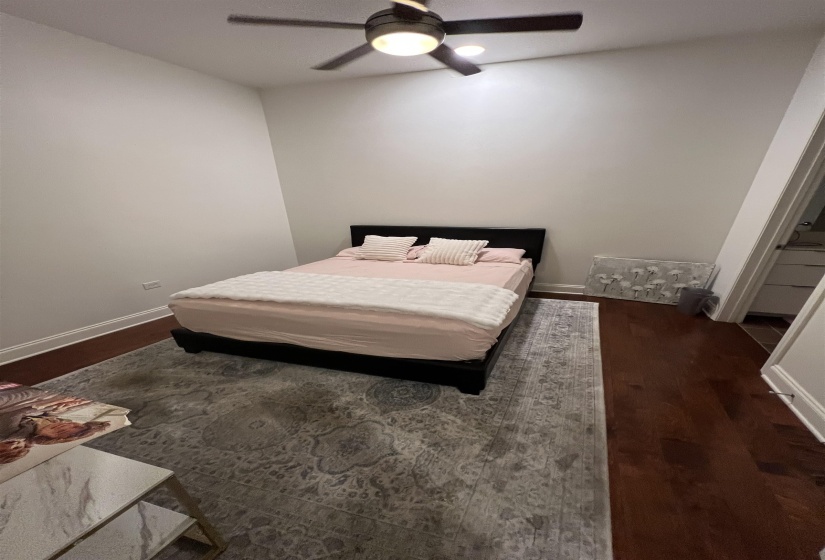 Bedroom featuring dark hardwood / wood-style floors and ceiling fan