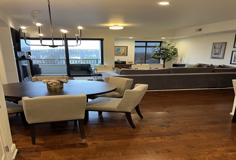 Dining space with dark hardwood / wood-style flooring and an inviting chandelier