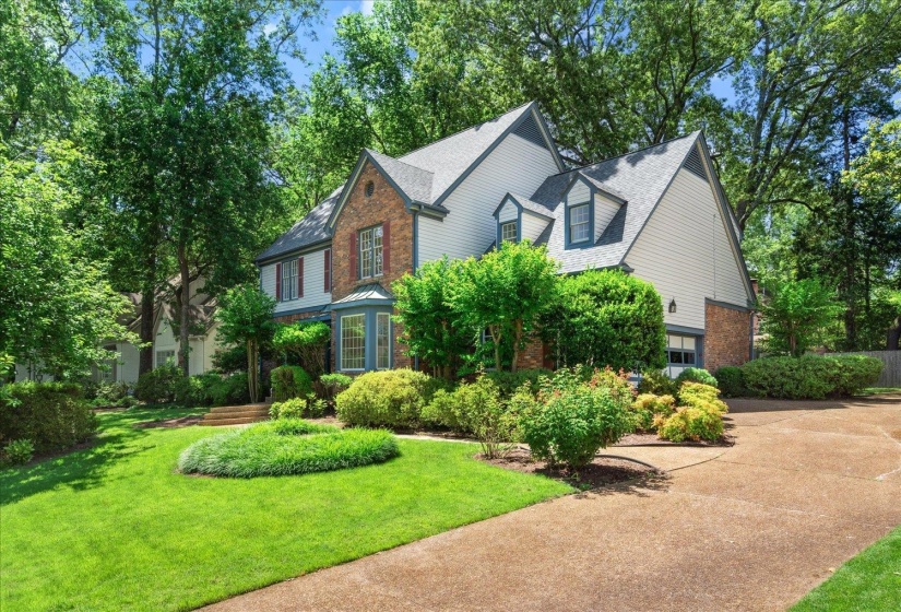 Large driveway leads to two car garage