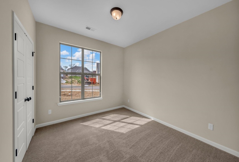 Unfurnished room featuring baseboards, visible vents, and carpet