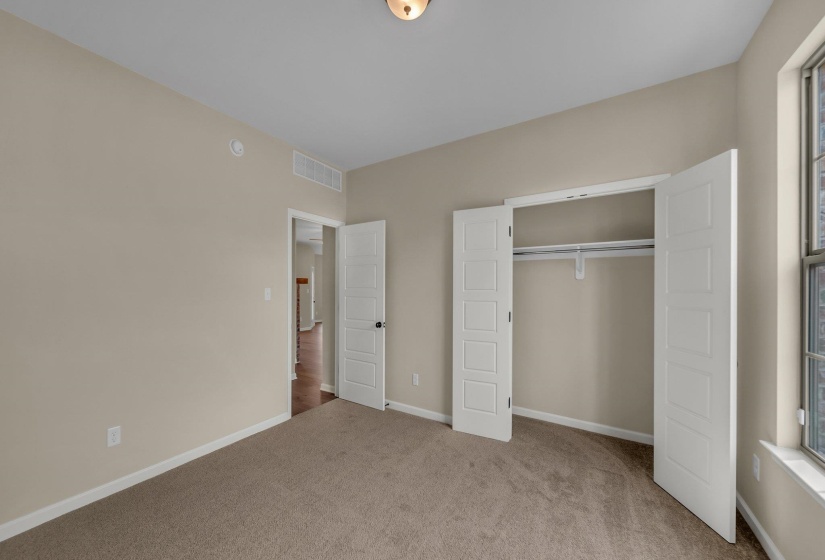 Unfurnished bedroom featuring baseboards, visible vents, a closet, and carpet