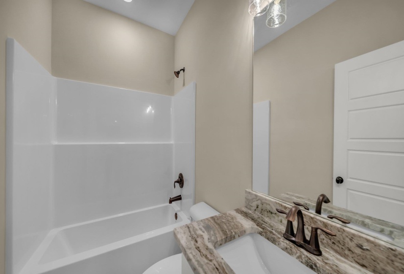 Bathroom with toilet, vanity, and shower / bath combination