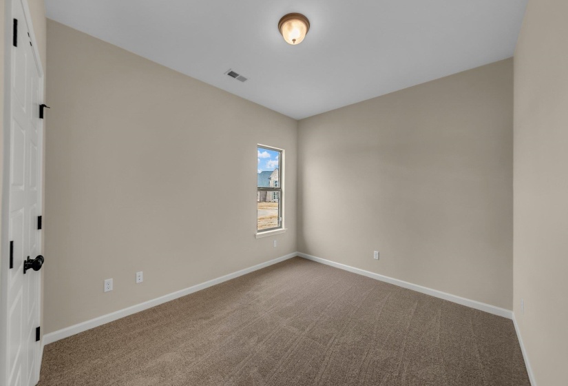 Carpeted empty room with baseboards and visible vents