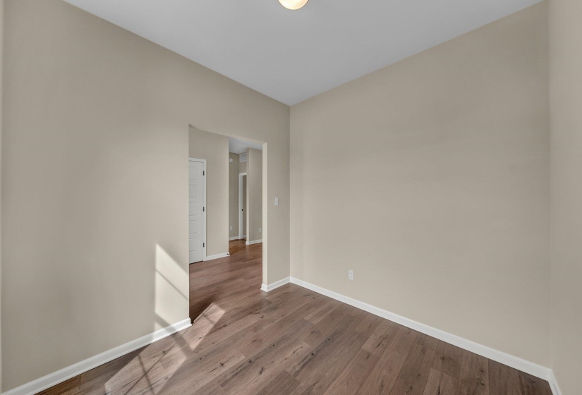 Empty room with baseboards and wood finished floors
