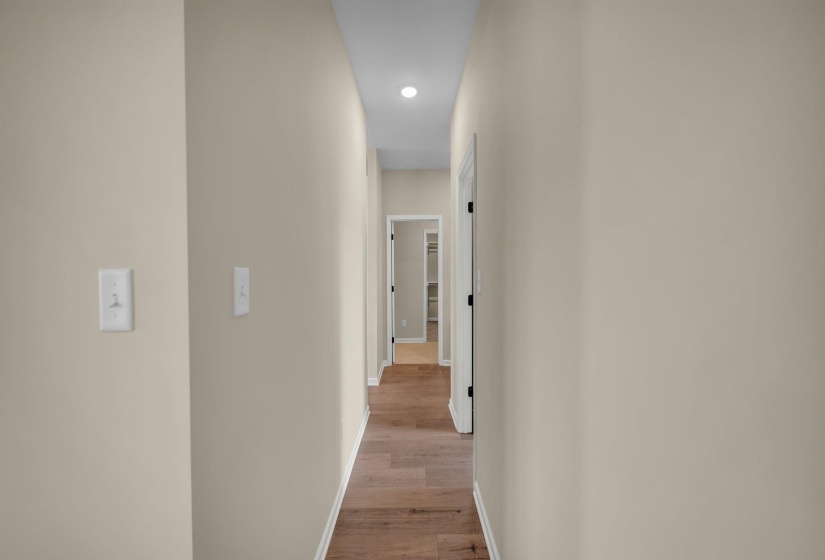 Hallway featuring baseboards and light wood-style floors