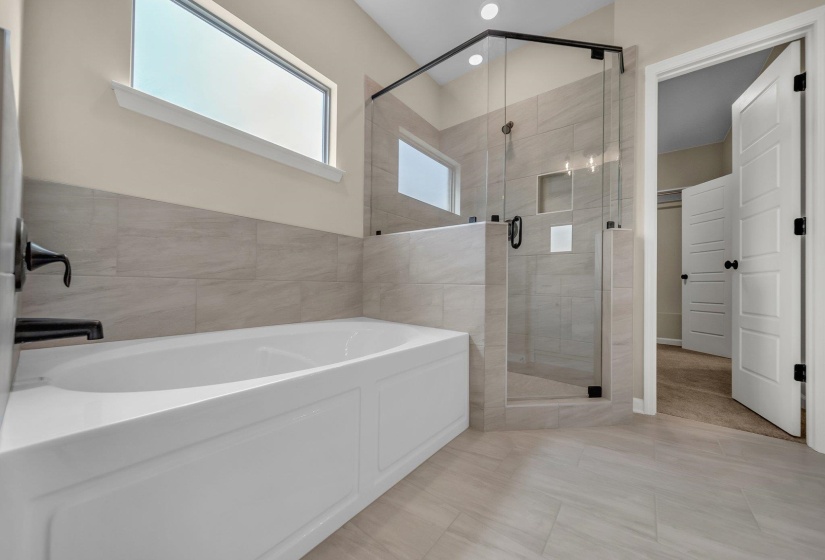 Bathroom with a garden tub and a shower stall