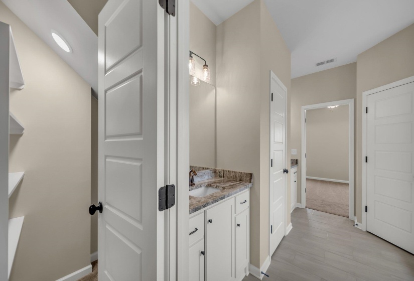 Bathroom featuring vanity, baseboards, and visible vents