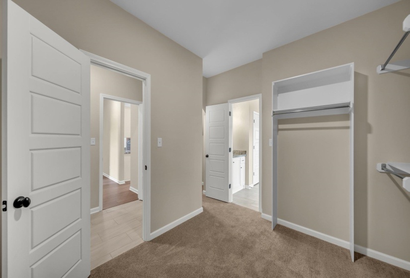 Unfurnished bedroom with carpet flooring, a closet, and baseboards