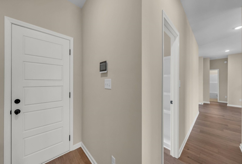 Corridor with recessed lighting, baseboards, and wood finished floors