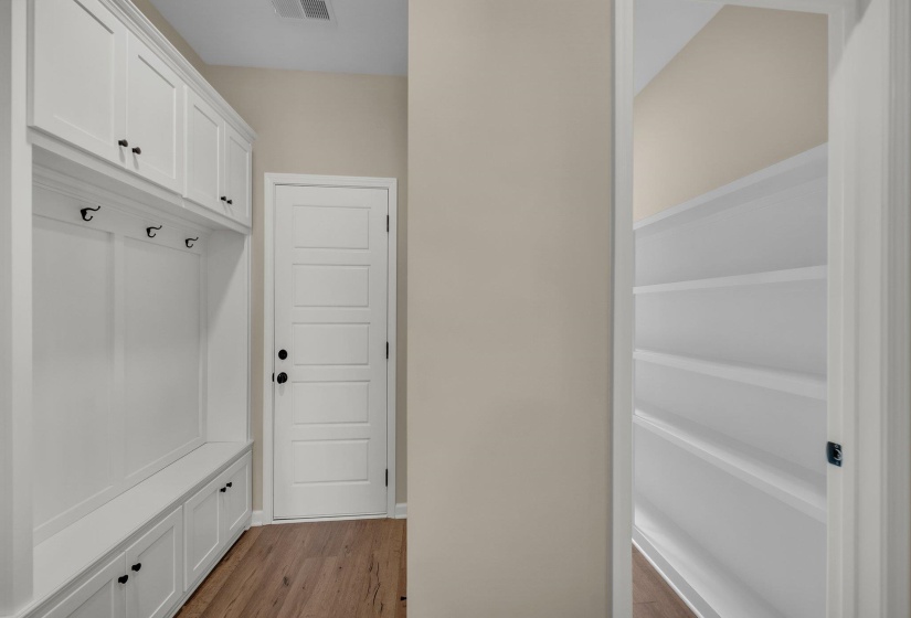 Mudroom with visible vents and light wood finished floors